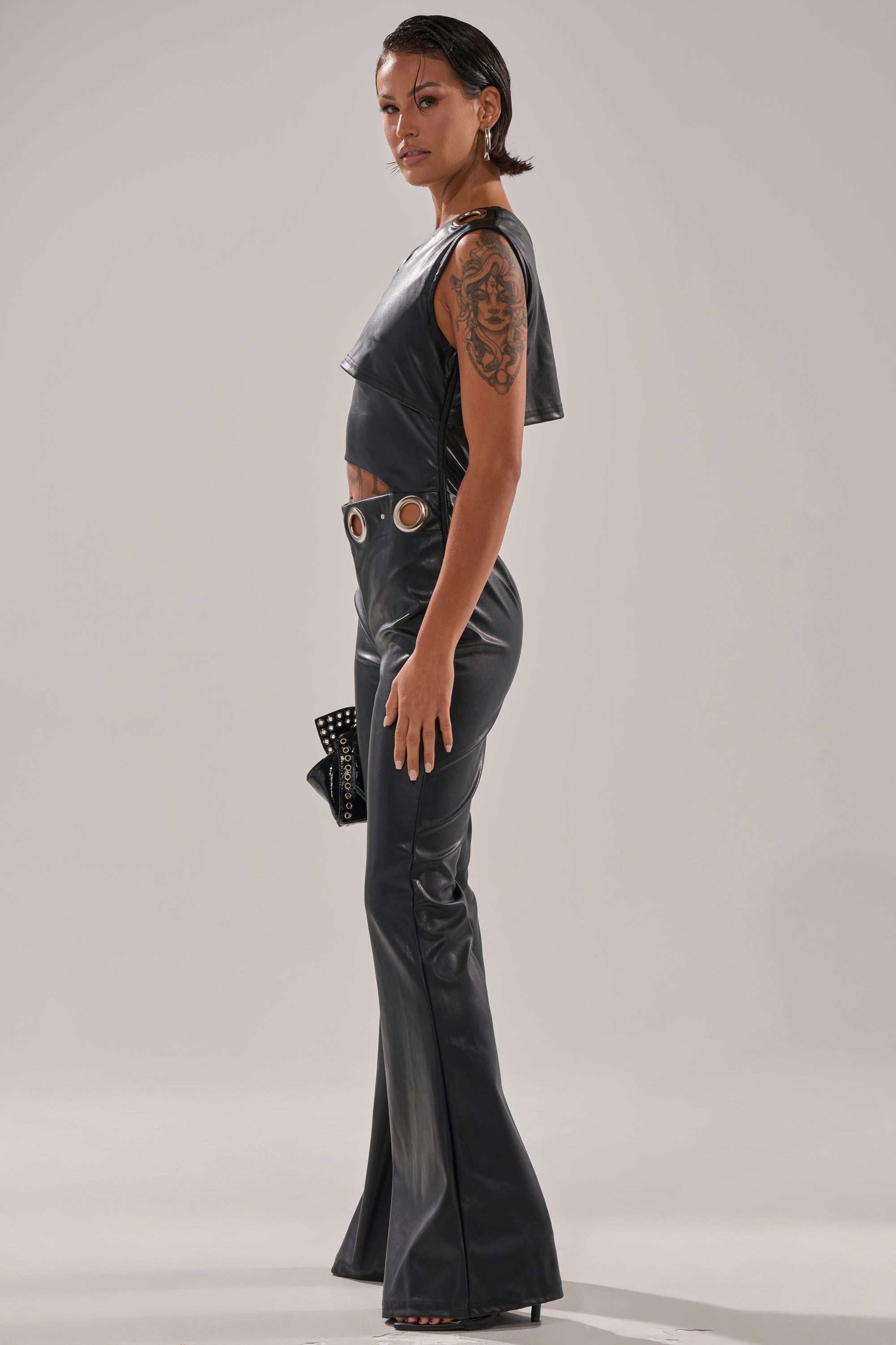 NO ONE LIKE ME PU JUMPSUIT WITH GROMMETS