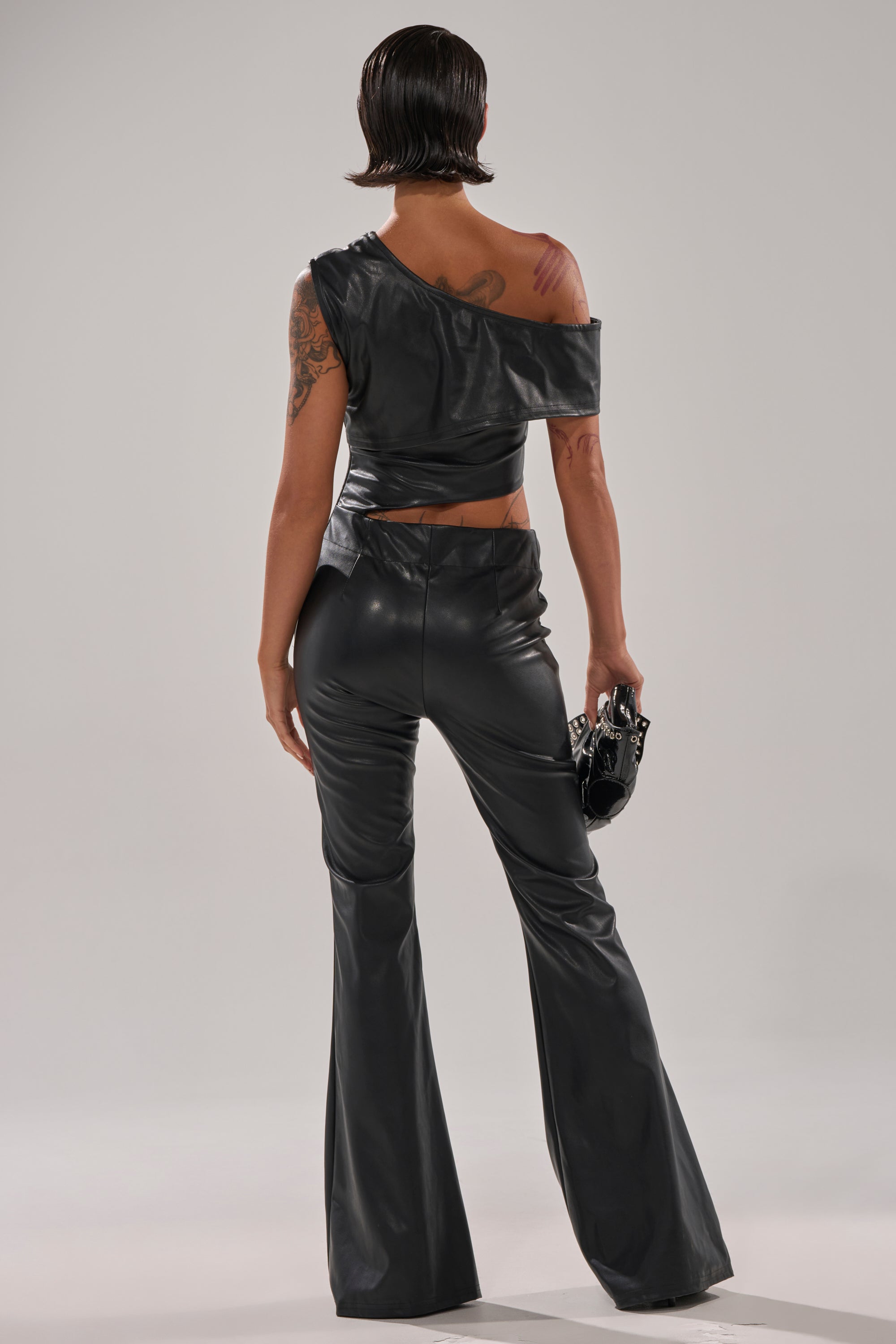 NO ONE LIKE ME PU JUMPSUIT WITH GROMMETS